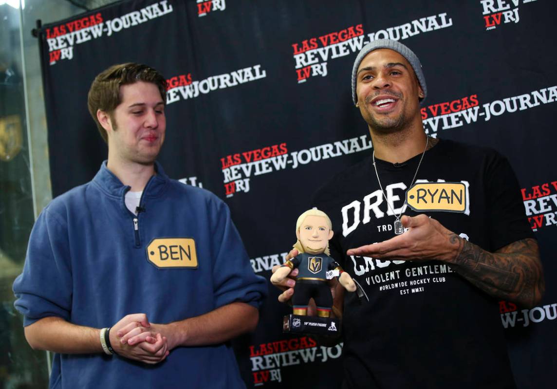 Golden Knights forward Ryan Reaves, right, holds a William Karlsson doll while participating in ...