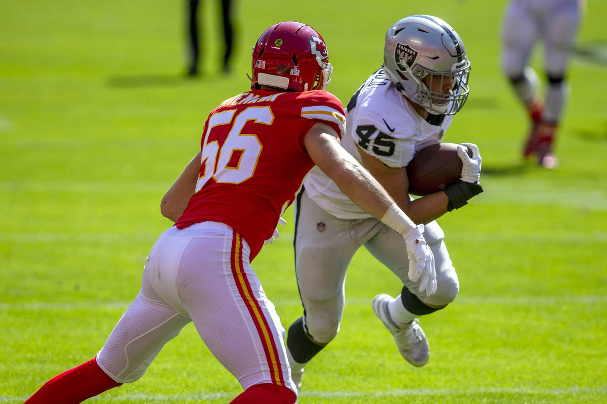 Las Vegas Raiders fullback Alec Ingold (45) runs with the football as Kansas City Chiefs lineba ...