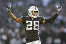 In this Dec. 15, 2013 file photo, Oakland Raiders defensive back Phillip Adams (28) gestures wh ...