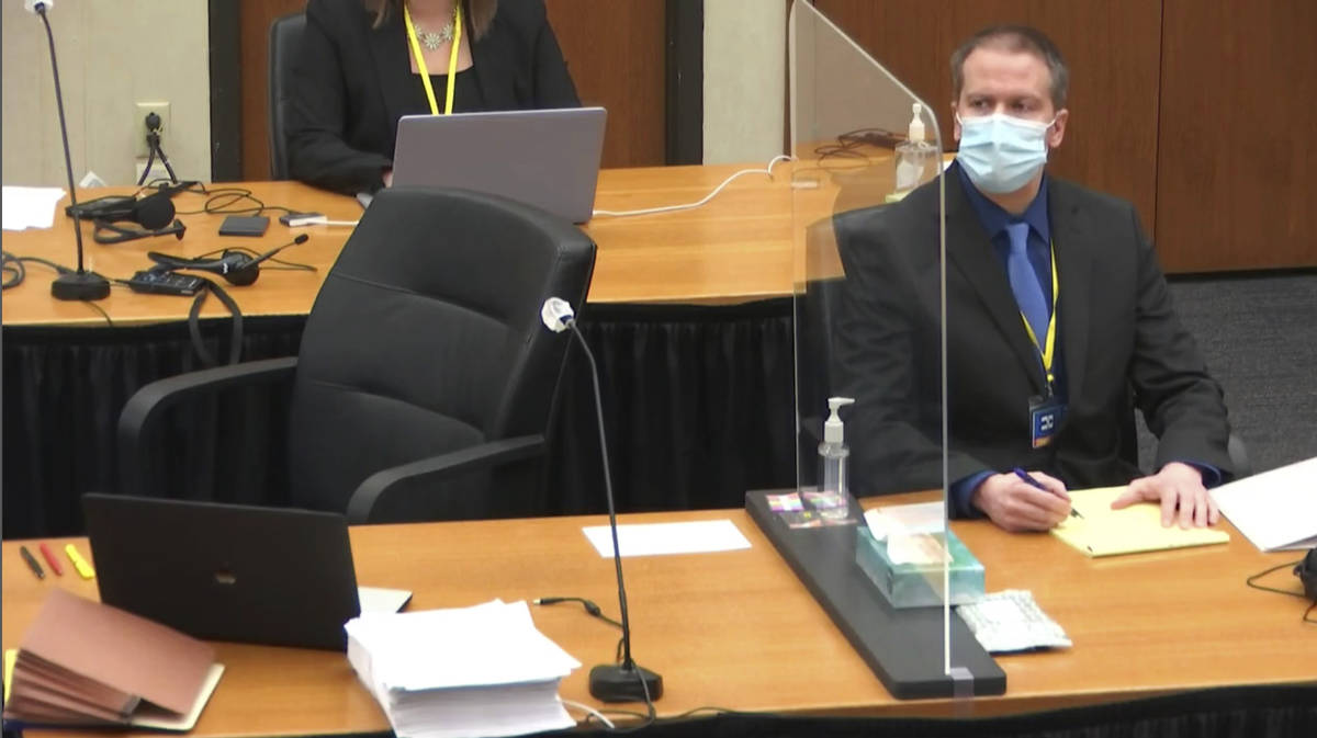 In this image taken from video, former Minneapolis police Officer Derek Chauvin watches as defe ...