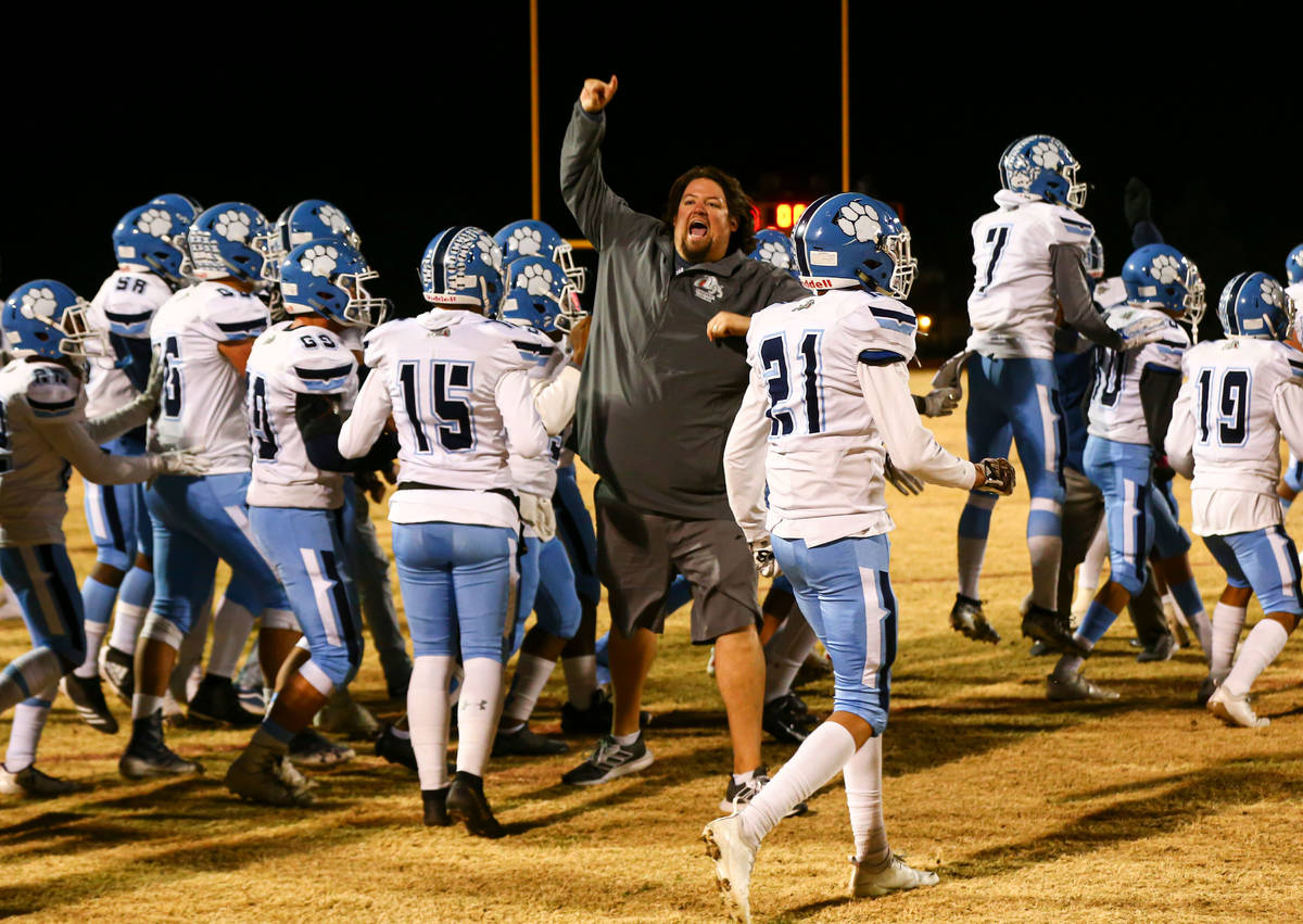 Centennial head coach Dustin Forshee celebrates after his team's 20-7 win over Desert Pines in ...