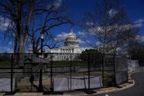 The U.S. Capitol is seen behind security fencing after a car that crashed into a barrier on Cap ...