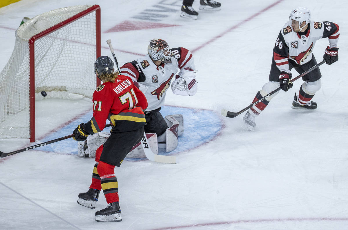 Golden Knights center William Karlsson (71) looks on as a puck goes past Arizona Coyotes goalte ...