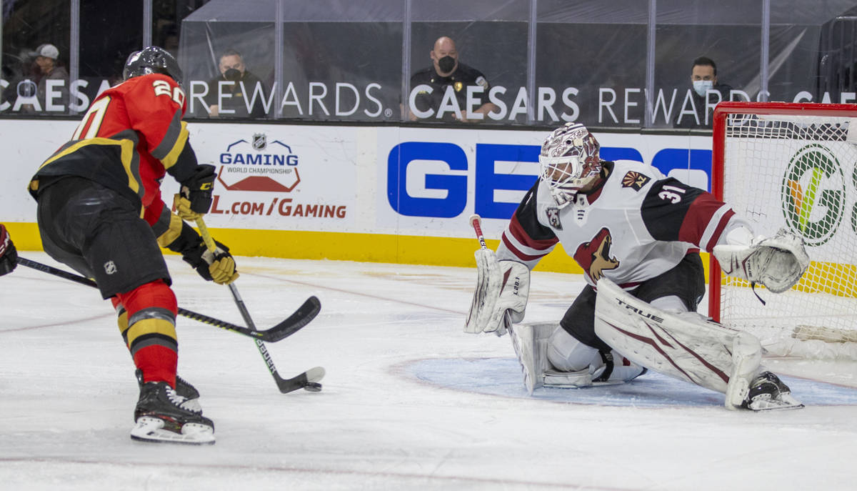 Golden Knights center Chandler Stephenson (20) prepares to score over Arizona Coyotes goaltende ...