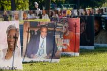 Some of the nearly 900 poster-sized photos of Detroit victims of COVID-19 are displayed on Bell ...