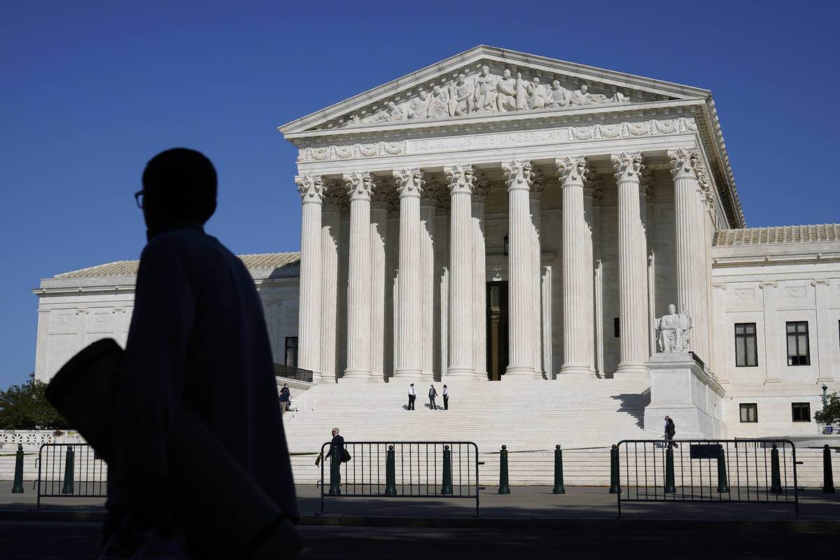Officials stand on the Supreme Court steps on Capitol Hill in Washington, Tuesday, Sept. 22, 20 ...