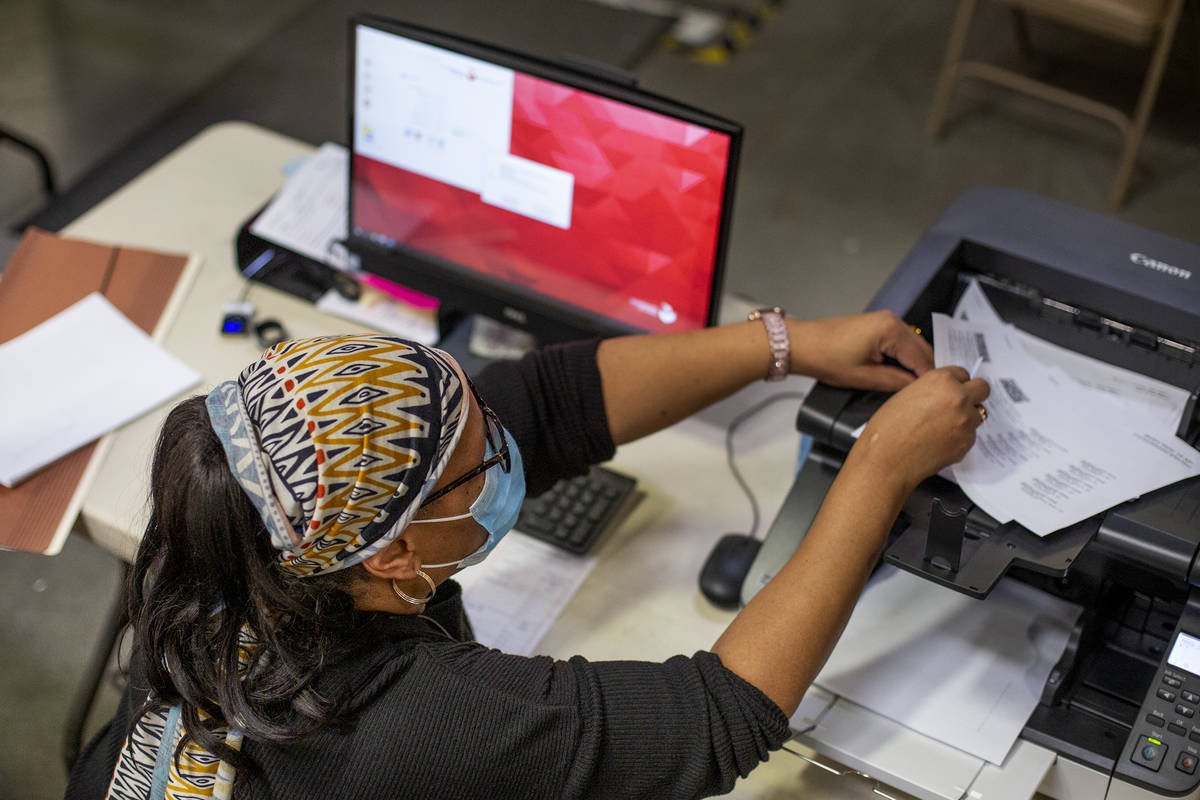 Mail-in ballots are counted at Clark County Election Center on Wednesday, Nov. 4, 2020, in Las ...