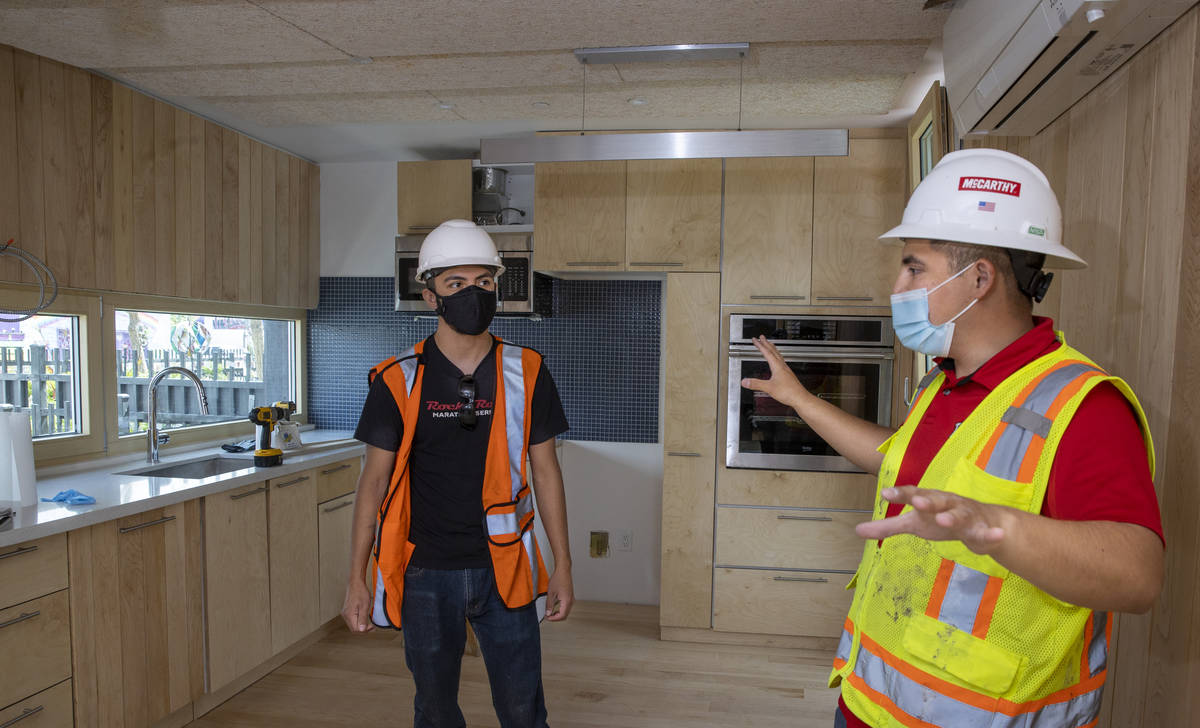 Students Alejandro Munoz, right, and Miguel Vazquez talk about the work left to do in the kitch ...