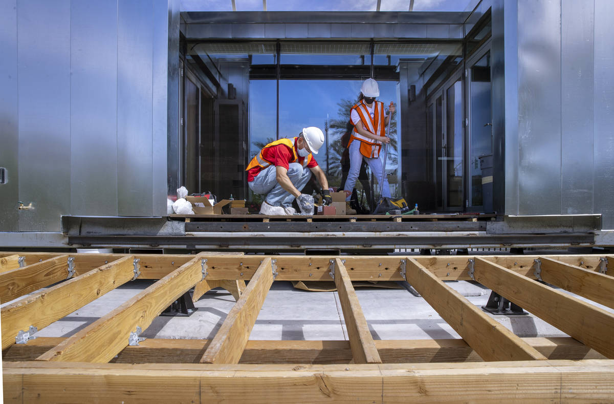 Student Jorge Medina, left, begins to assemble parts for a deck soon to be installed as a UNLV ...