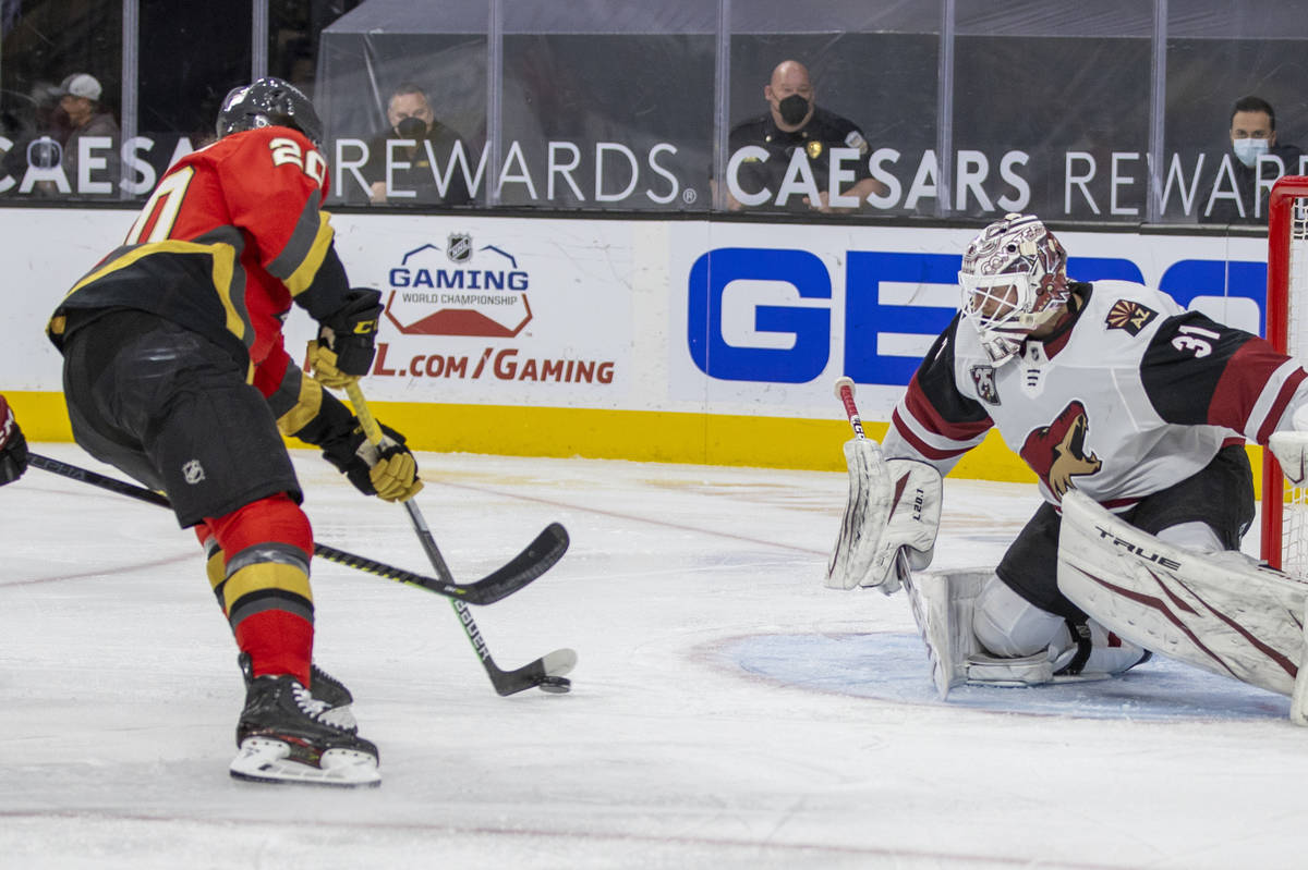 Golden Knights center Chandler Stephenson (20) prepares to score over Arizona Coyotes goaltende ...