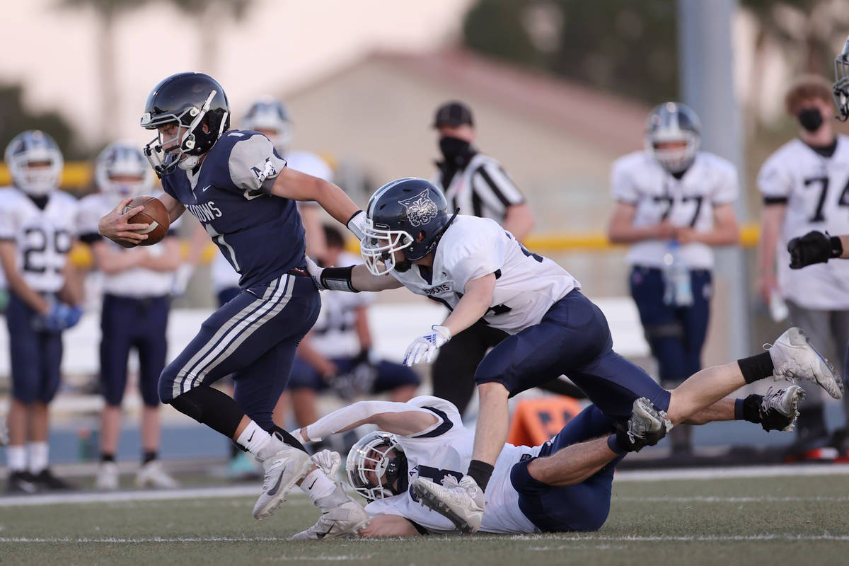 Meadow's Michael Corrigan (1) dodges tackles from White Pine's Tristin Gubler (24) and Jack Ces ...