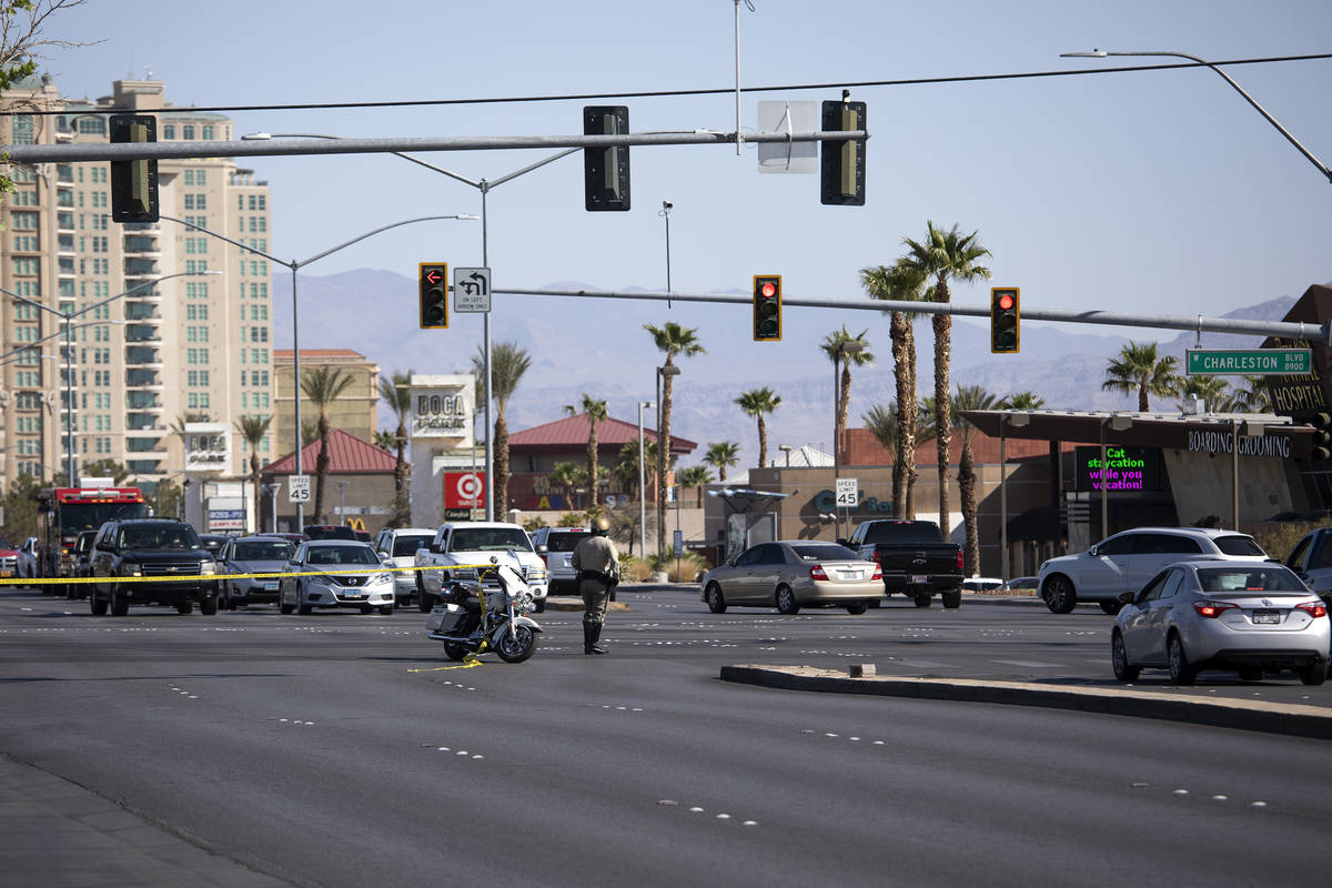 South Fort Apache Road is blocked off while homicide detectives investigate after a woman's bod ...