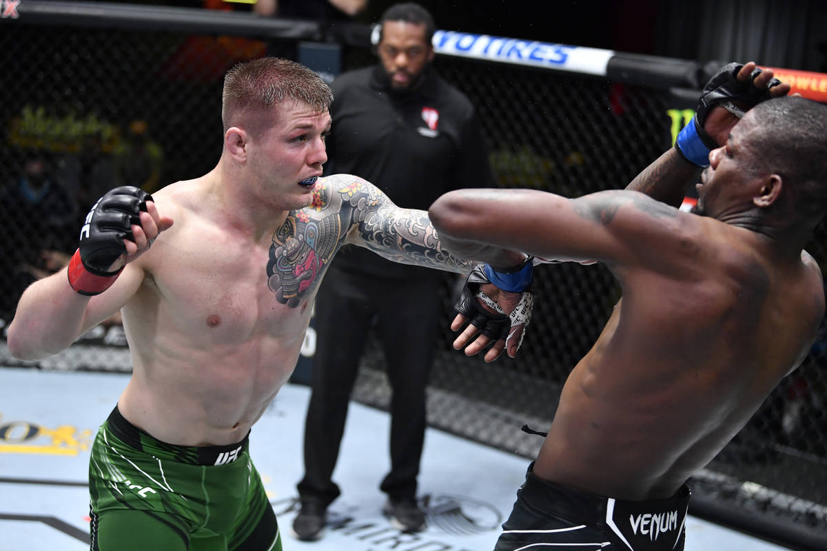 LAS VEGAS, NEVADA - APRIL 10: (L-R) Marvin Vettori of Italy punches Kevin Holland in a middlewe ...