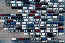 Mid-sized pickup trucks and full-size vans are seen in a parking lot outside a General Motors a ...