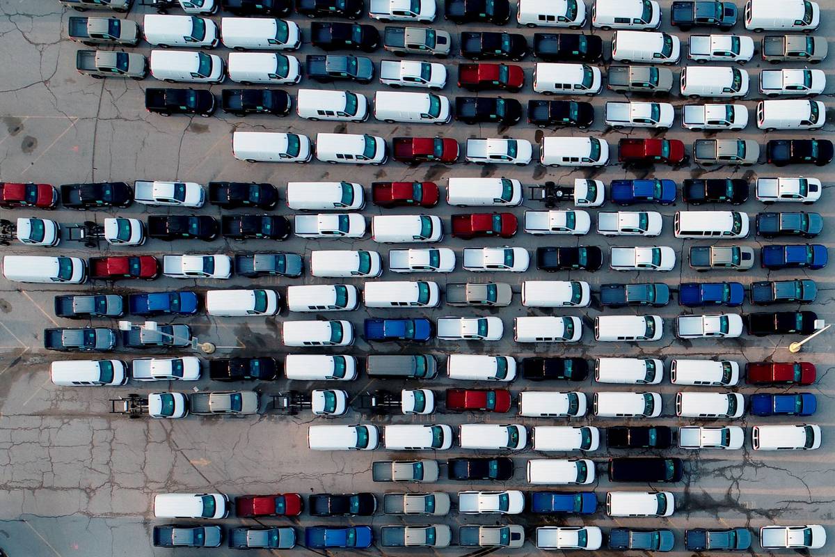 Mid-sized pickup trucks and full-size vans are seen in a parking lot outside a General Motors a ...
