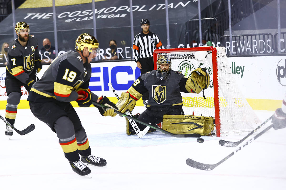 Golden Knights goaltender Marc-Andre Fleury (29) and forward Reilly Smith (19) defend the net a ...