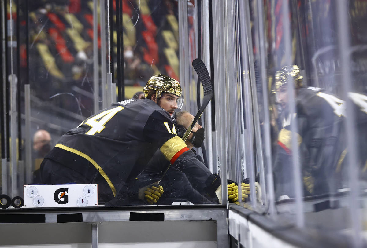 Golden Knights' Nicolas Hague (14) watches the action from the penalty box during the first per ...