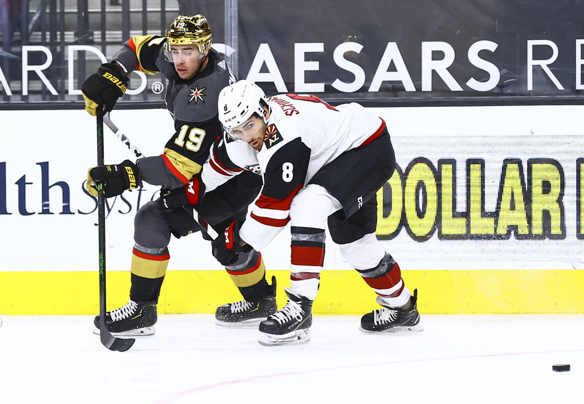 Golden Knights' Reilly Smith (19) passes the puck under pressure from Arizona Coyotes' Nick Sch ...