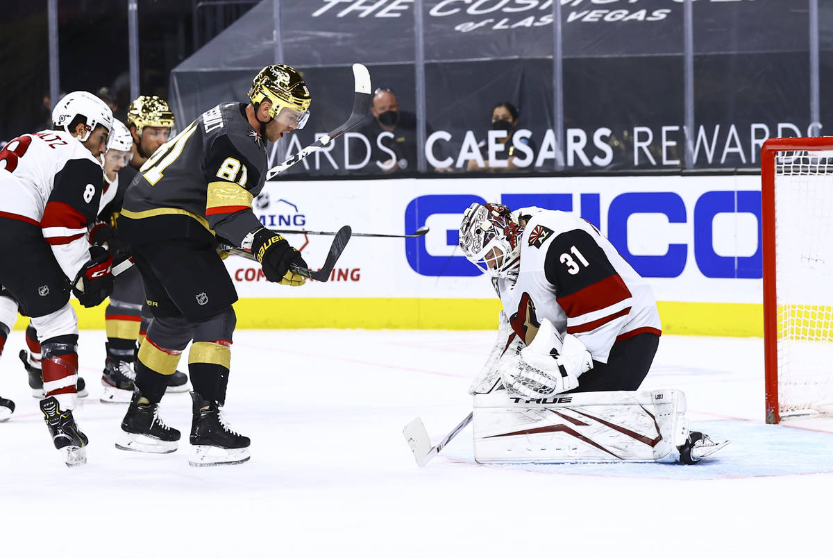 Arizona Coyotes goaltender Adin Hill (31) stops the puck in front of Golden Knights' Jonathan M ...