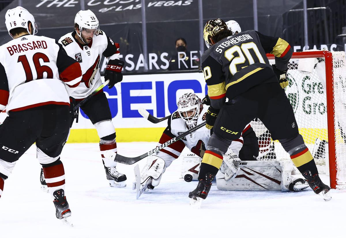 Arizona Coyotes goaltender Adin Hill (31) reaches out to stop the puck in front of Golden Knigh ...