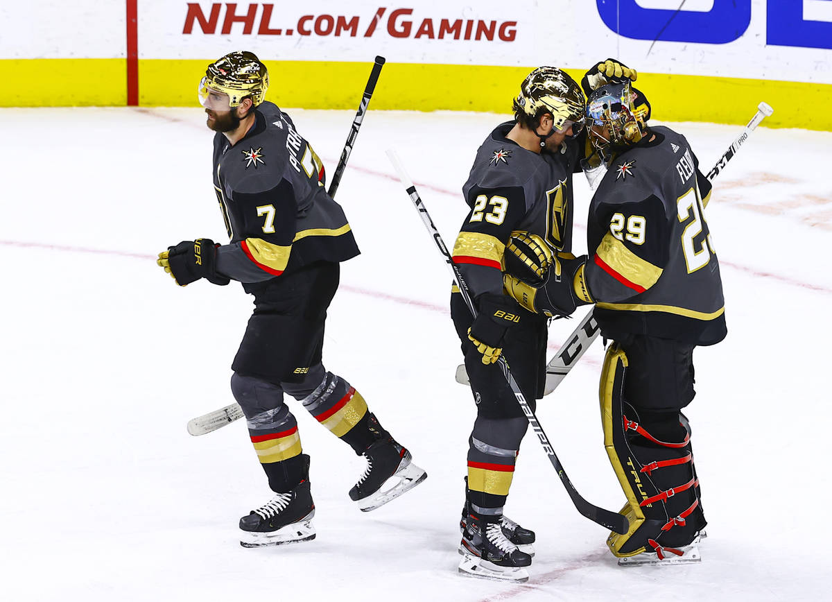Golden Knights' Alec Martinez (23) celebrates with goaltender Marc-Andre Fleury (29) after a sh ...