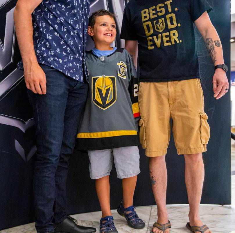 Young Golden Knights fan Jordyn Weatherholt, 9, is pleased to be standing between NHL player Ma ...