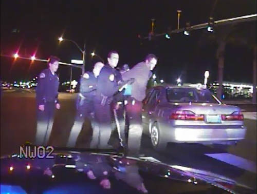 Nevada Highway Patrol video from 2010 shows officers helping handcuffed motorist Adam Greene up ...