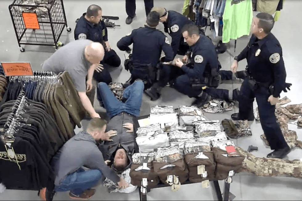 A screenshot from Sportsman’s Warehouse surveillance video shows Herndon on the ground being ...