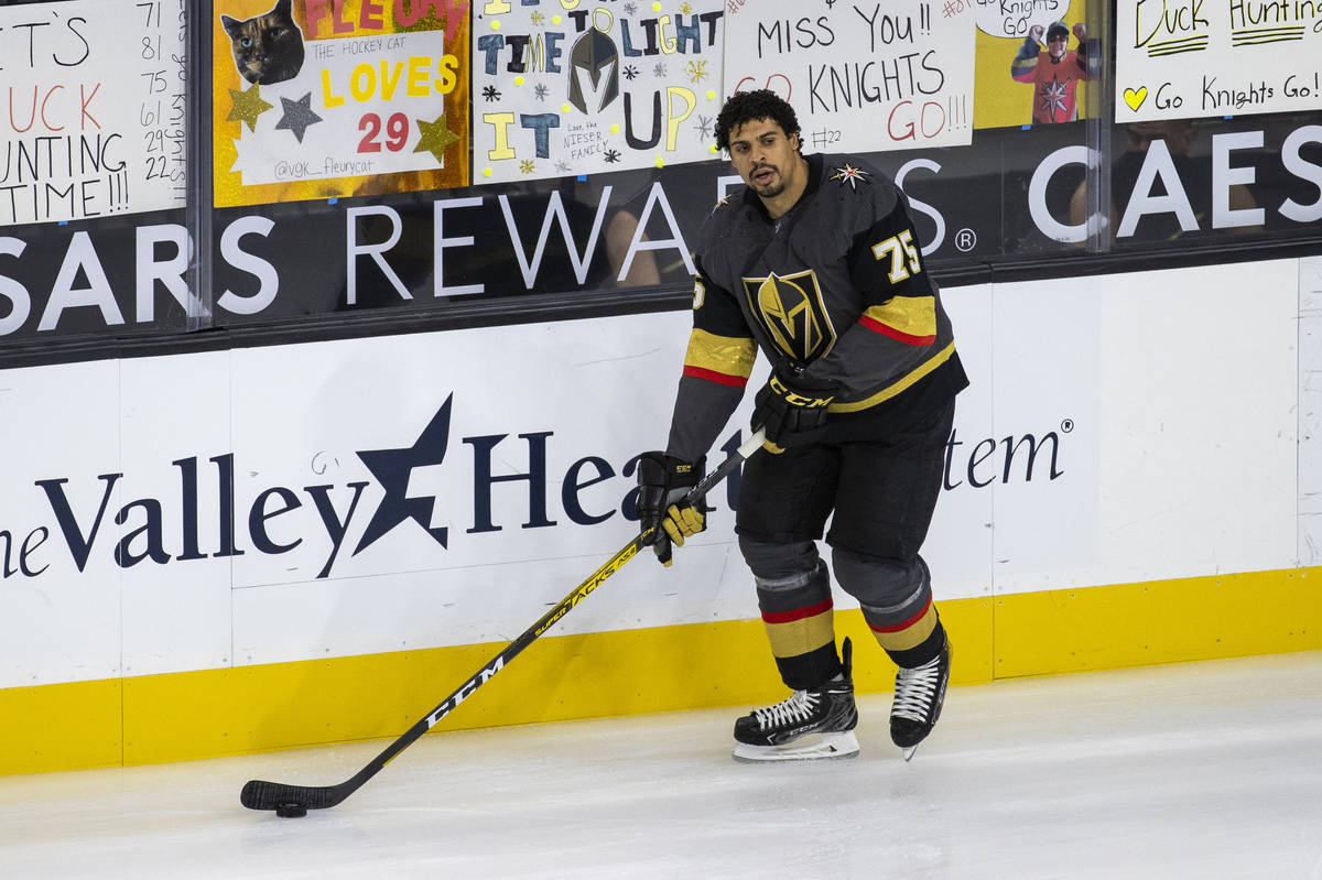 Golden Knights right wing Ryan Reaves (75) skates by handwritten signs from fans during the war ...
