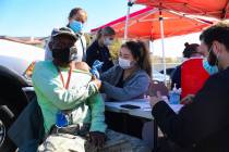 Debbie Min, right, a physician assistant student from Touro University, administers a COVID-19 ...