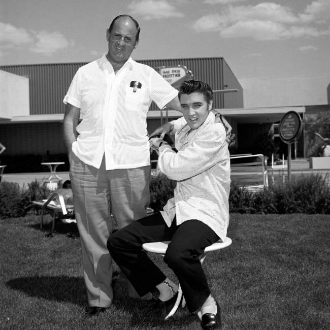 Elvis Presley takes publicity photos with his manager, Colonel Tom Parker, at the New Frontier ...