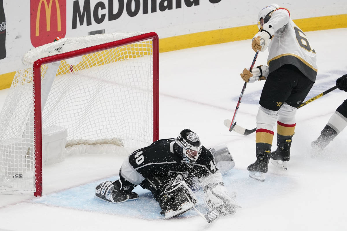 Los Angeles Kings goaltender Calvin Petersen, left, is scored on by Vegas Golden Knights right ...