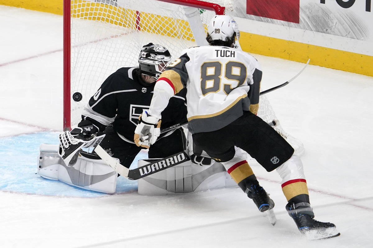 Vegas Golden Knights right wing Alex Tuch, right, scores on Los Angeles Kings goaltender Calvin ...
