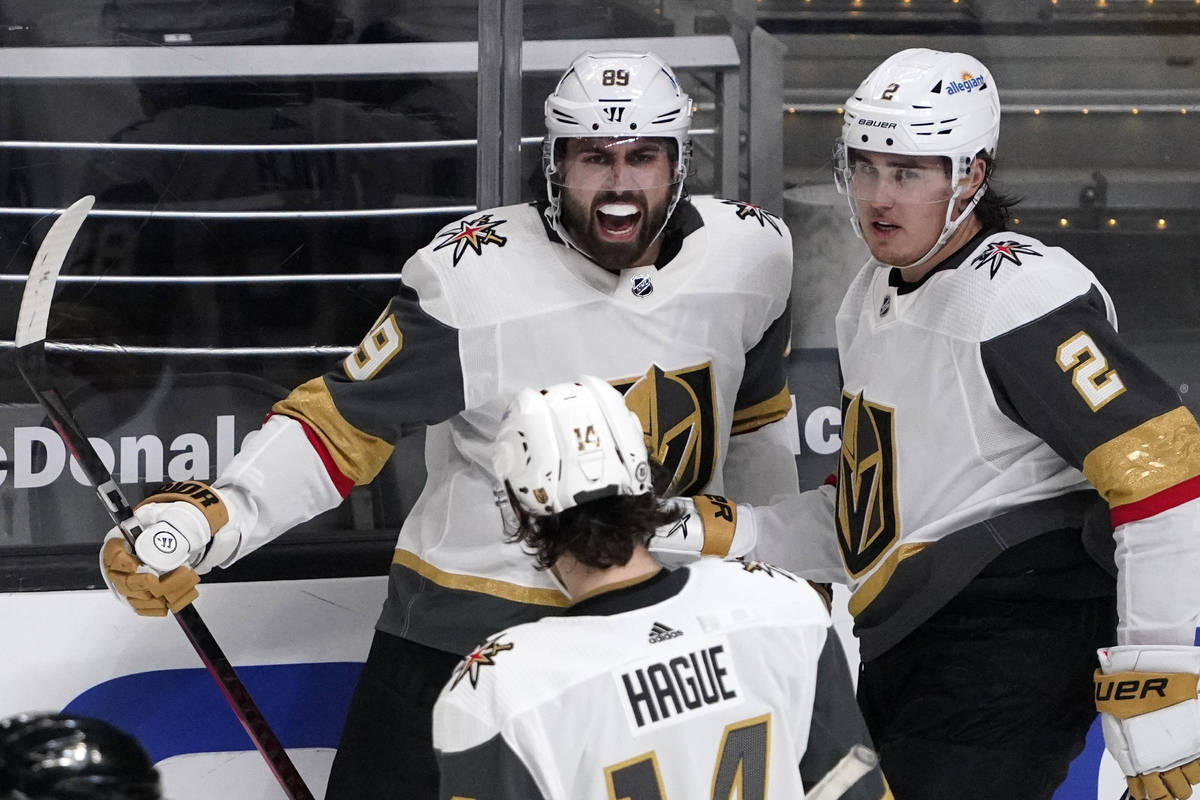 Vegas Golden Knights right wing Alex Tuch, center, celebrates his goal with defenseman Nicolas ...