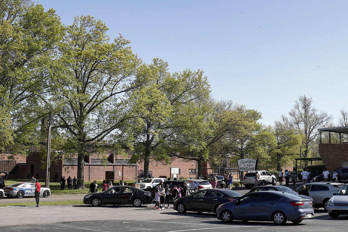 People gather outside Austin-East Magnet High School in Knoxville, Tenn., as Knoxville police w ...