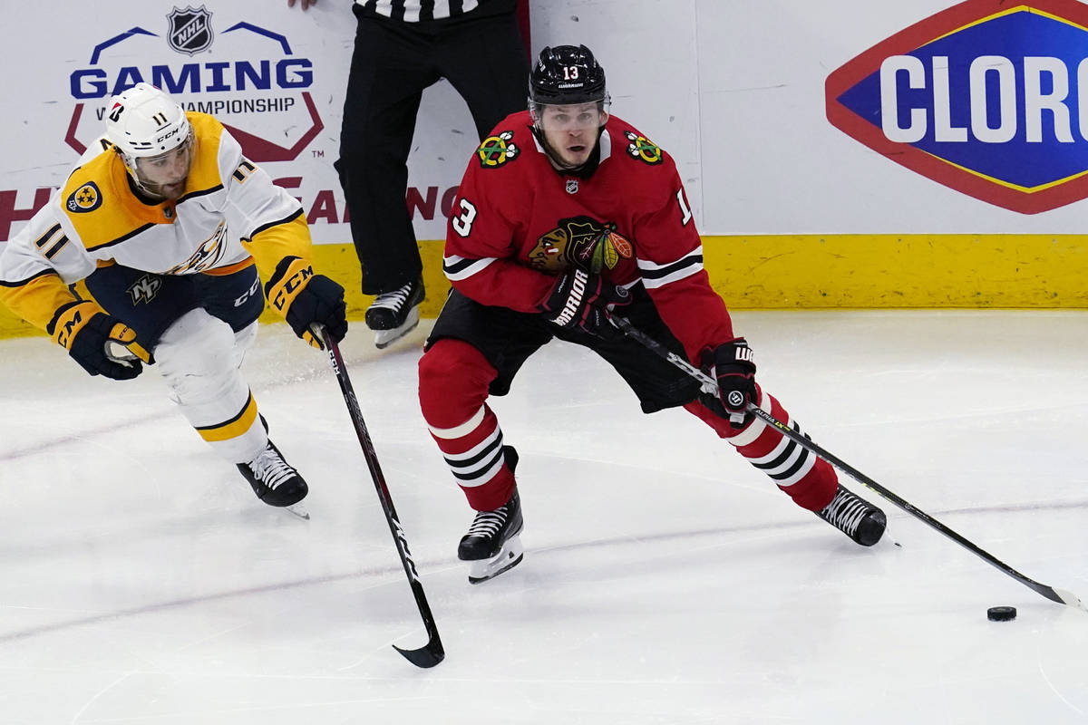 Chicago Blackhawks center Mattias Janmark, right, is defended by Nashville Predators center Luk ...