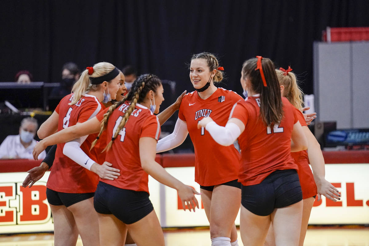Mountain West Player of the Year Mariena Hayden (center) gathers with UNLV volleyball players a ...