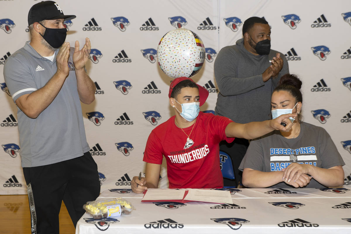 Desert Pines senior Anthony Swift, second from left, sits next to his mother Jay Douwes, and co ...