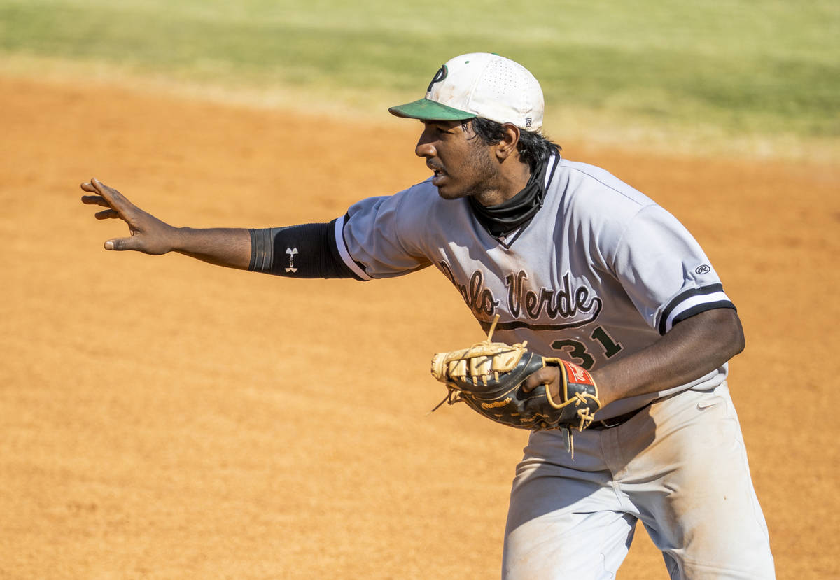 Palo Verde 1B Karthik Gondy (31) signals he will tag the base himself versus Basic during an NI ...