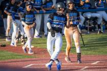 BasicÕs Hunter Katschke (10) scores a run and closes the extra innings gap to one run vers ...