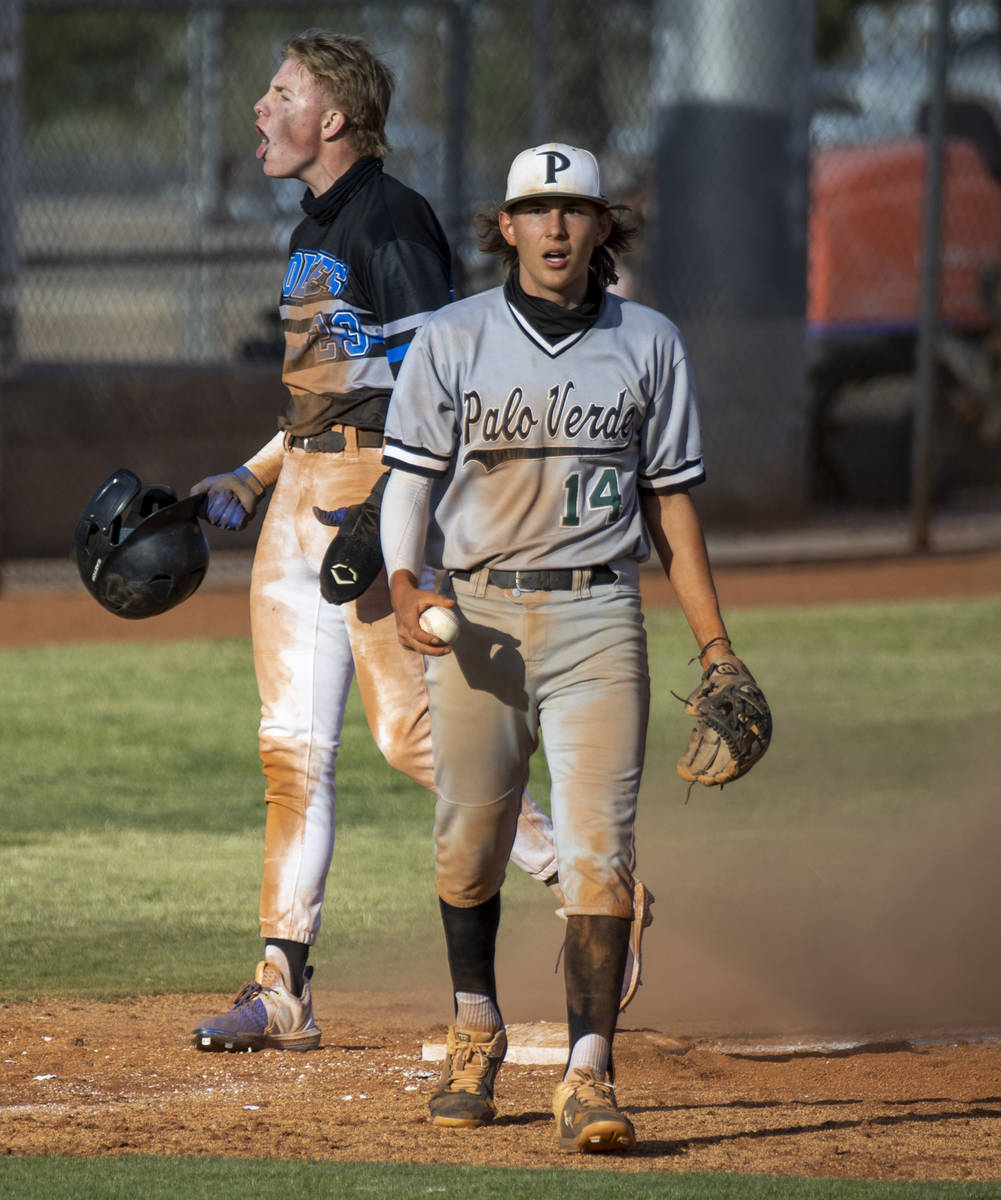 Palo Verde 3B Cal Erickson (14) is surprised as Basic runner Cooper Sheff (23) sadly makes it t ...