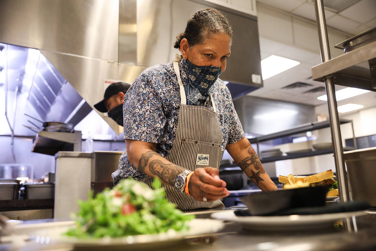 Chef Natalie Young preps food to be expedited at one of her restaurants, Old Soul, at the World ...