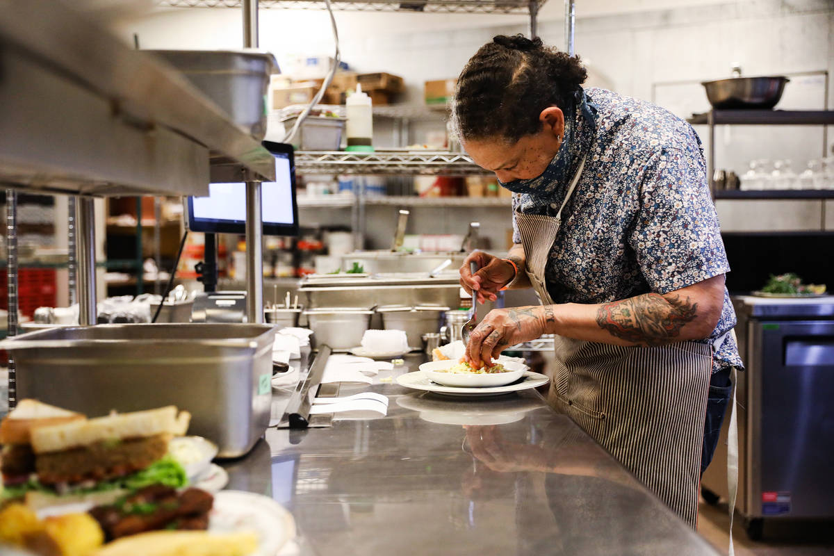 Chef Natalie Young preps food to be expedited at one of her restaurants, Old Soul, at the World ...