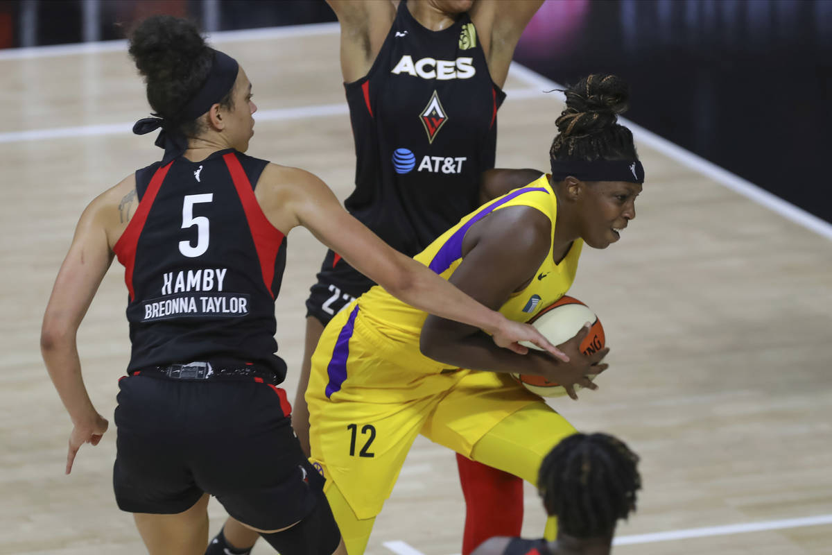 Los Angeles Sparks' Chelsea Gray (12) drives past Las Vegas Aces' Dearica Hamby during the seco ...