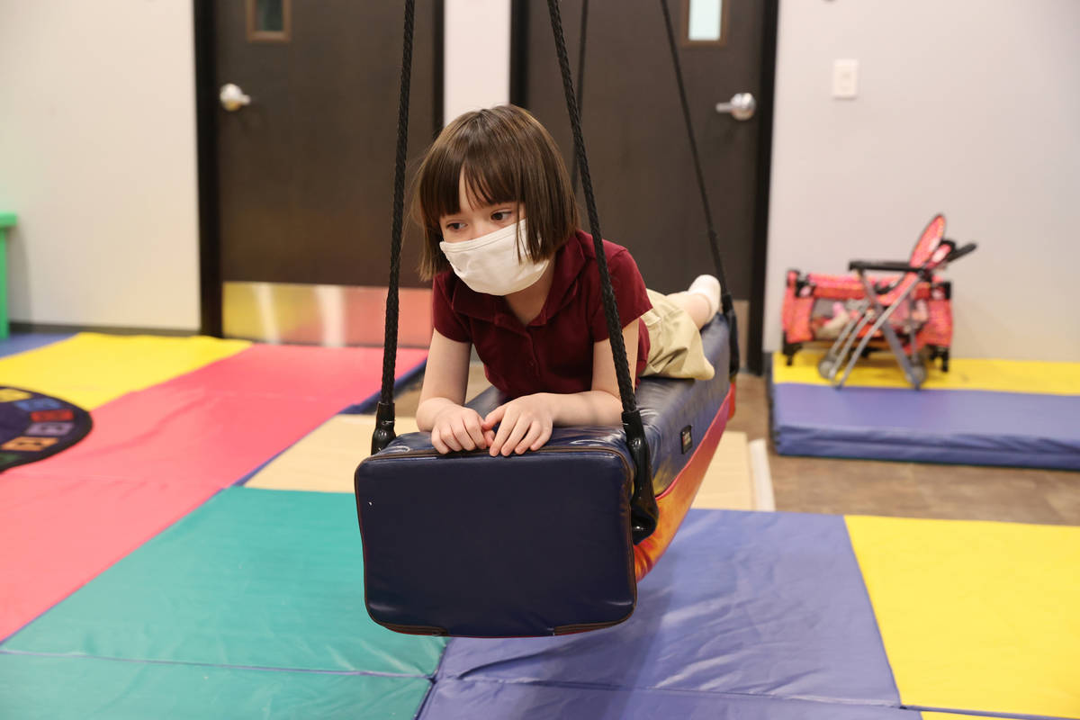 Akara Haase, 6, takes a break in a learning and play area called The Park at the Center for Aut ...