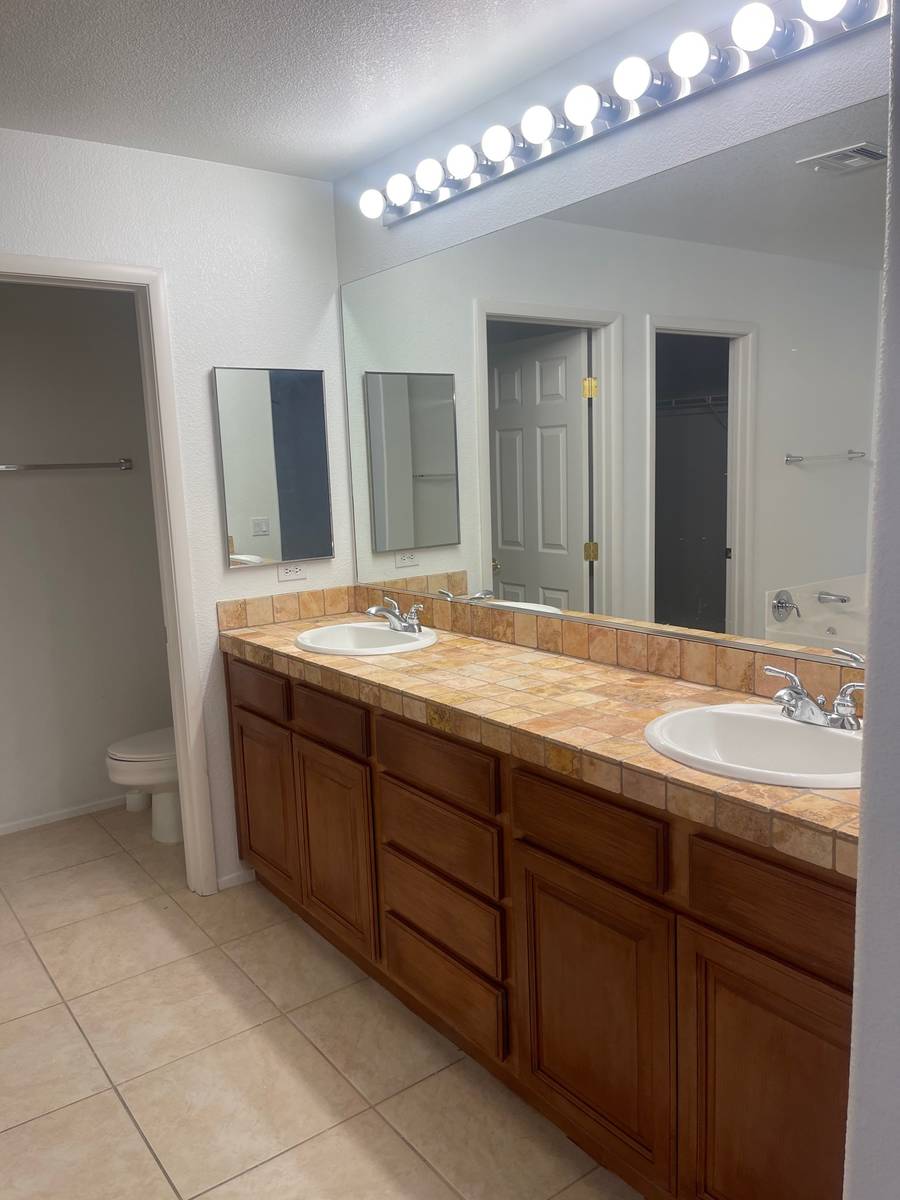 The bathroom of 5720 Deer Brush Court, North Las Vegas offers plenty of space between the vanit ...