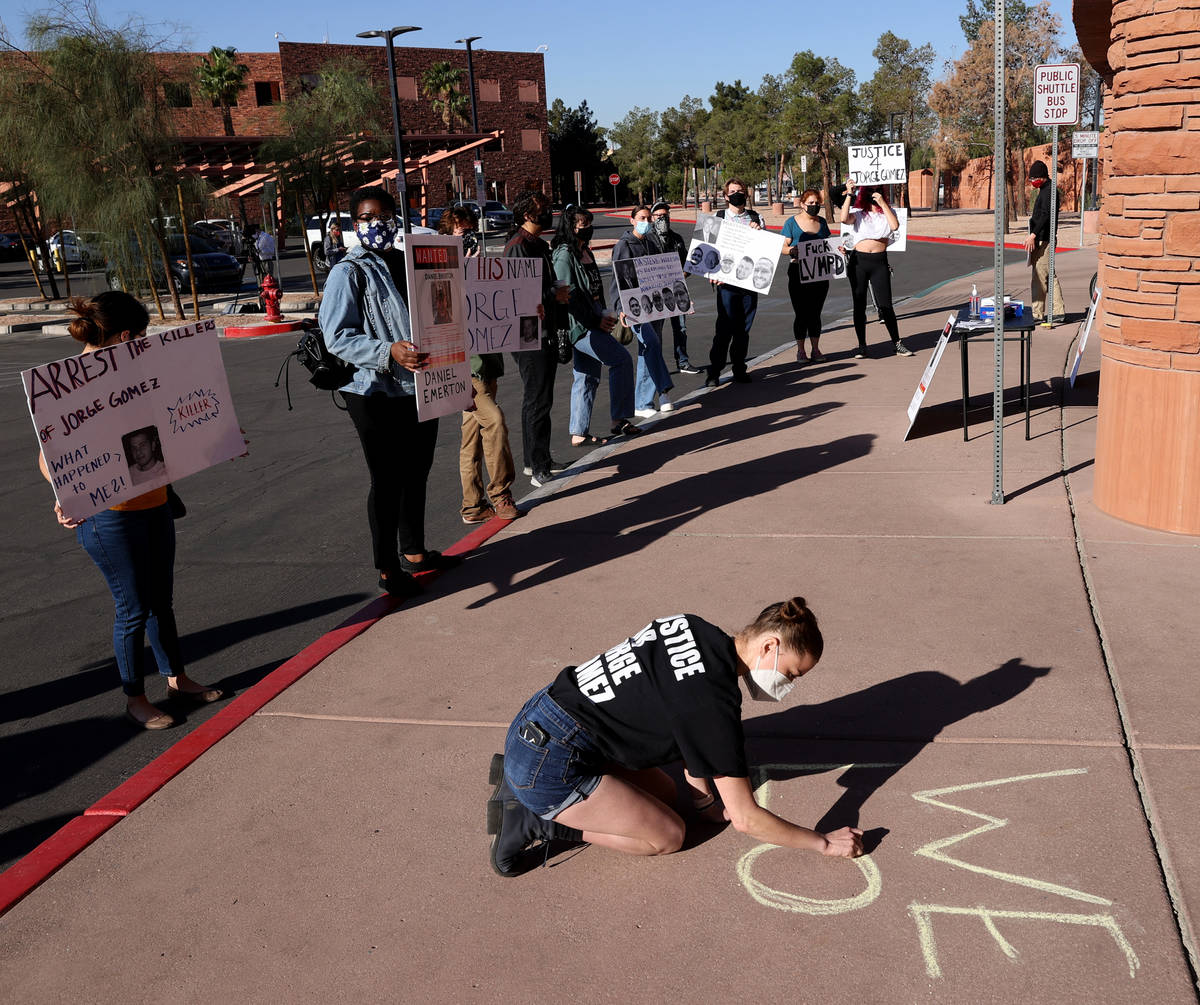 Jazz Appin of Las Vegas writes on the sidewalk outside the main entrance to the Clark County Go ...