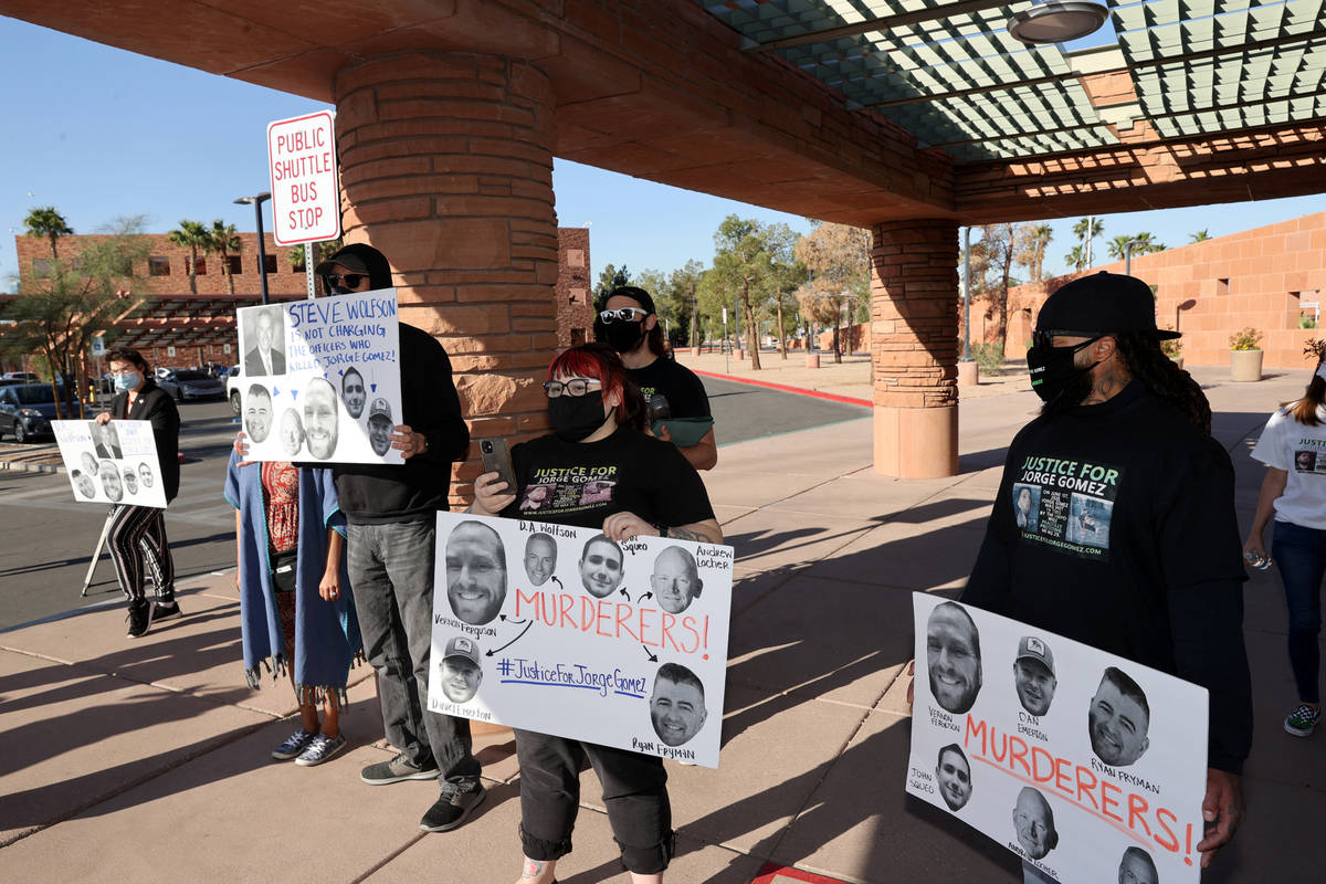 Chaun Knox, from right, Kat Kallina and Jerry Vlasak protest outside Clark County Government Ce ...