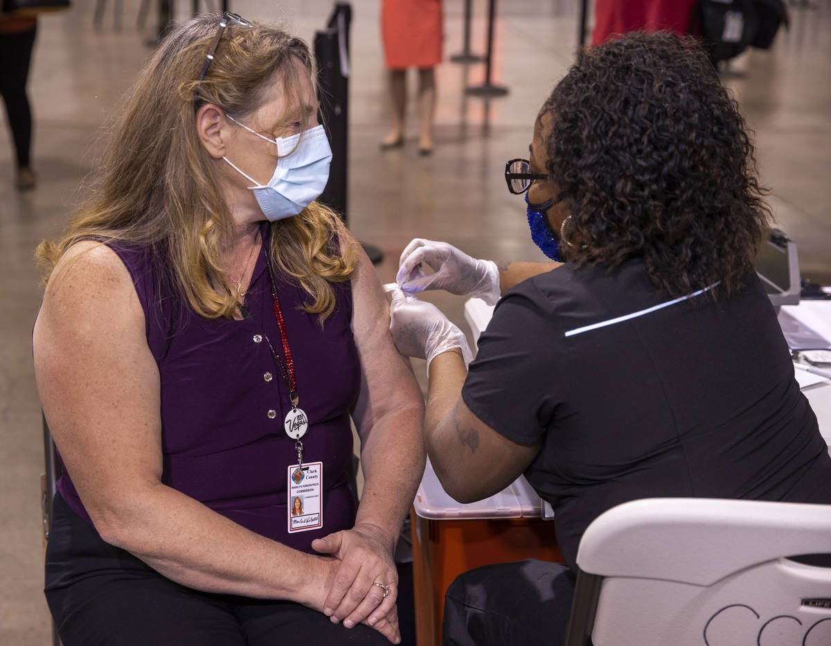 Commissioner Marilyn Kirkpatrick, left, receives her second vaccine dose from Impact health's N ...