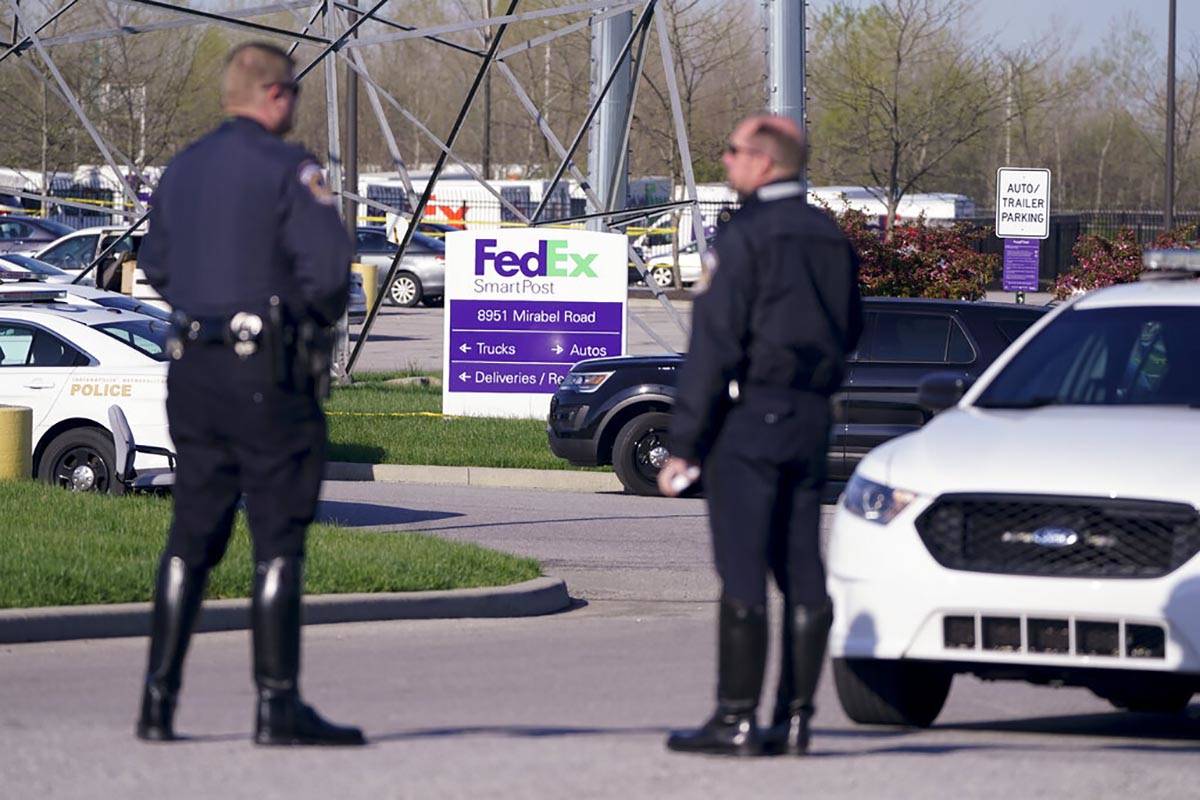 Police stand near the scene where multiple people were shot at the FedEx Ground facility early ...